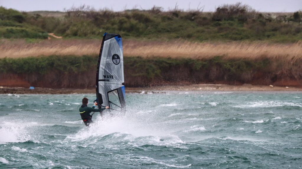 Dave from All Winds windsurfing in a 50-knot Bora storm in Croatia—extreme katabatic wind conditions unfit for bareboat sailing.