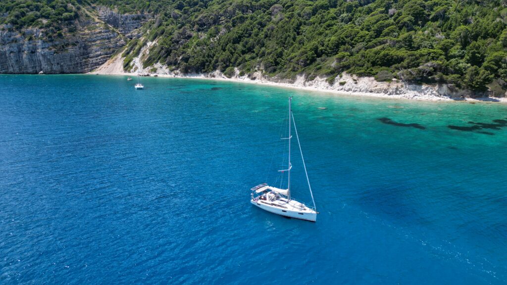 A yacht anchored at Sazana Island during an Albania cruising guide passage.