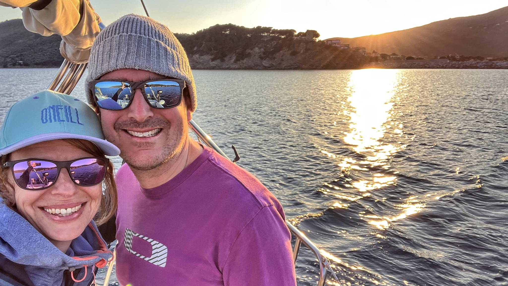 Dave and Karin on deck at sunset during a sailing passage.