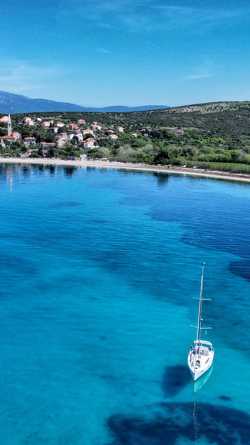 Charter Yacht anchored in a turquoise bay in the Mediterranean